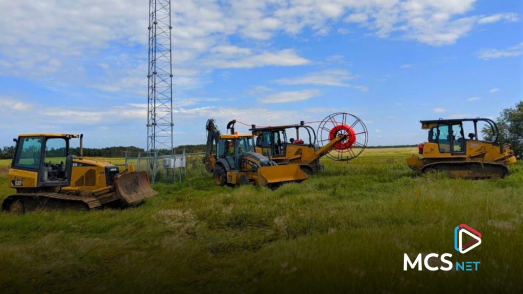 photo of fiber construction equipment in the countryside next to an MCSnet fixed wireless tower