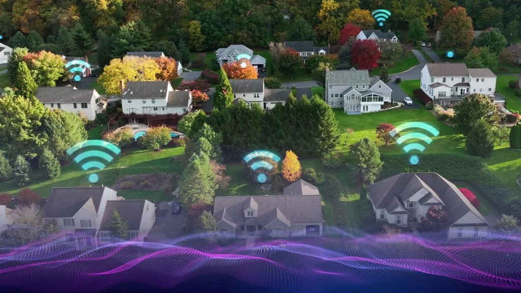 An overhead view of a rural community with digital Wi-Fi symbols over the roof of each house.
