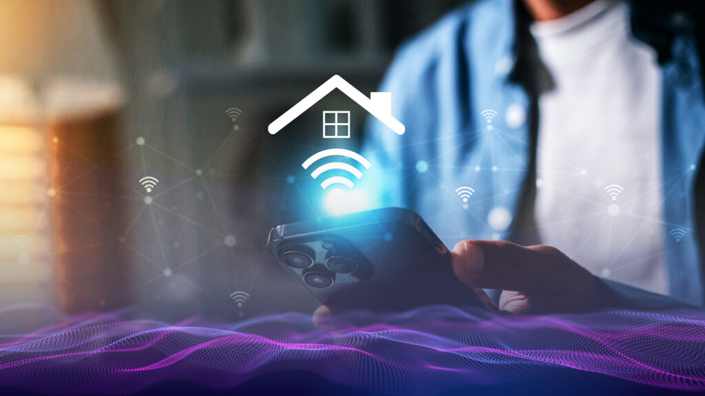 Zoomed in photo of a person hold a smart phone with the phone the highlight of the image. There are digital images of he Wi-Fi symbol as well as the roof frame and window of a house.